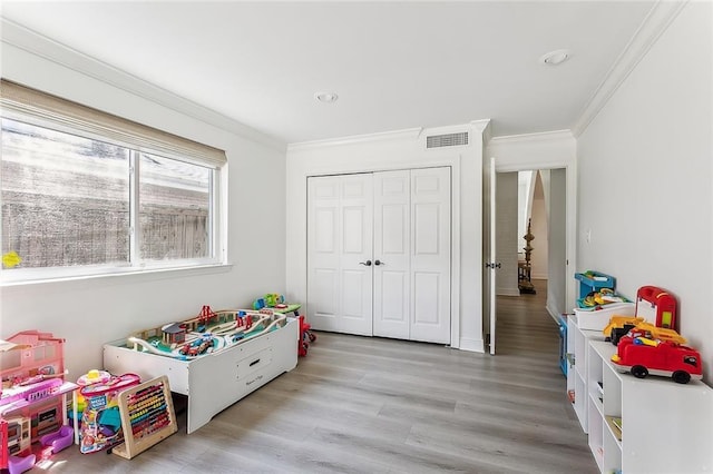 4524 Folse Dr, Metairie, LA 70006 - playroom featuring crown molding, light wood-style flooring, and visible vents