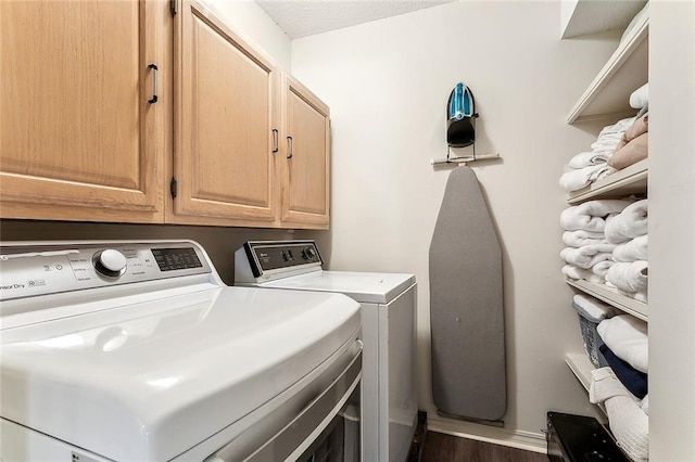 4524 Folse Dr, Metairie, LA 70006 - washroom with separate washer and dryer, cabinet space, and dark wood-type flooring
