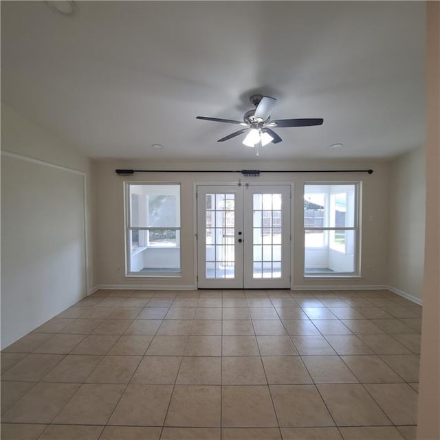 24 Caribou Ct, Metairie, LA 70003 - empty room featuring light tile patterned floors, a ceiling fan, french doors, and baseboards