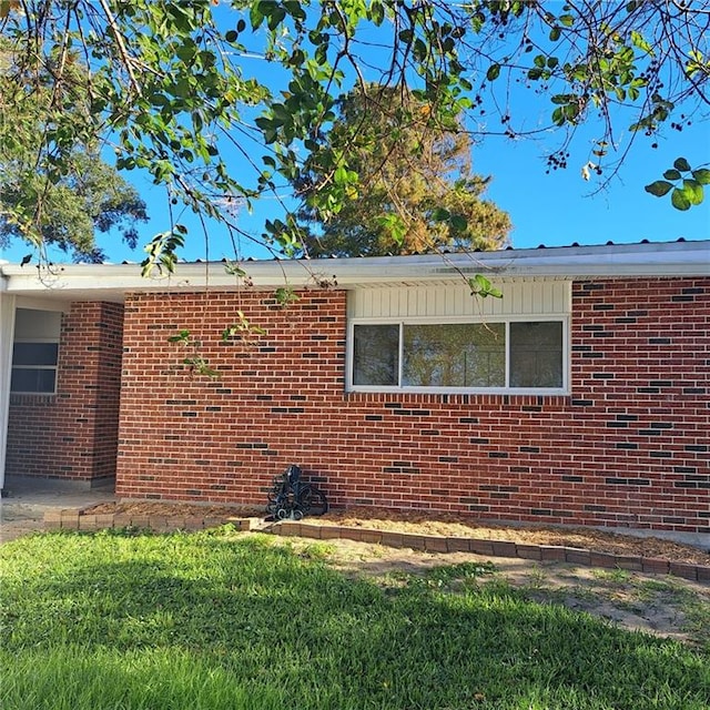 24 Caribou Ct, Metairie, LA 70003 - view of property exterior featuring brick siding and a lawn