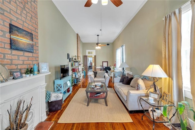 living area with ceiling fan and wood finished floors