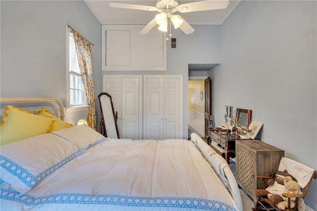 bedroom with a ceiling fan, visible vents, and a closet