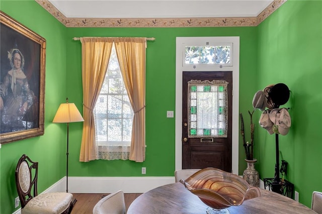 entryway featuring baseboards and wood finished floors