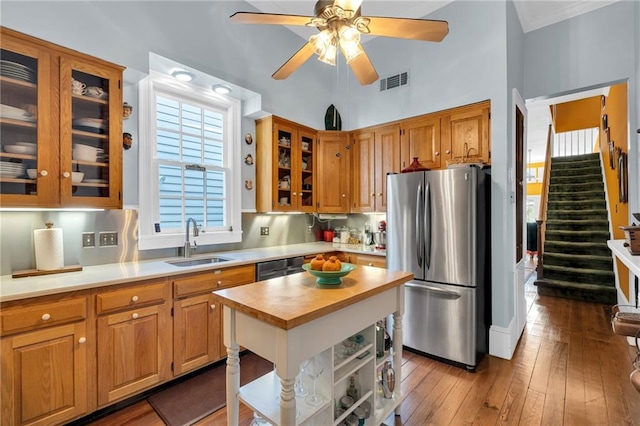 kitchen featuring ceiling fan, visible vents, a sink, wood counters, and stainless steel appliances