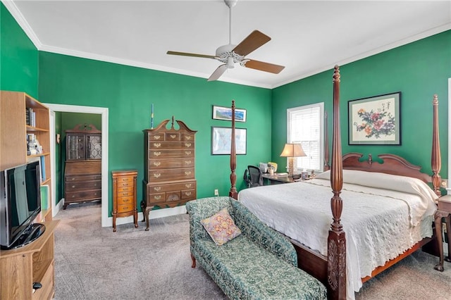 carpeted bedroom featuring baseboards, ornamental molding, and a ceiling fan