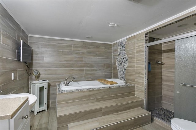full bathroom with ornamental molding, toilet, tile walls, a bath, and a shower stall