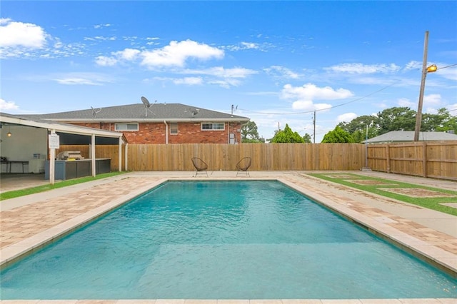 view of swimming pool with a fenced backyard, a fenced in pool, and a patio