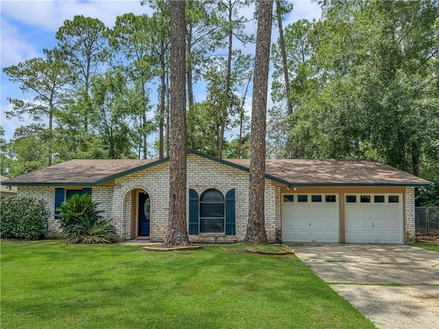 115 Spruce Cir, Slidell, LA 70458 - view of front of home with a garage, driveway, brick siding, and a front yard