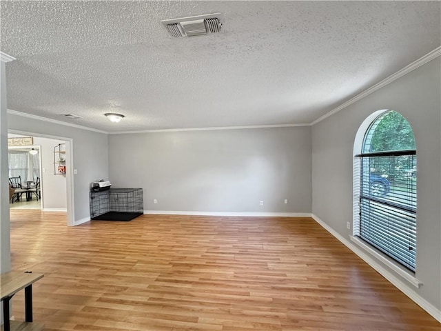 115 Spruce Cir, Slidell, LA 70458 - unfurnished living room with ornamental molding, a textured ceiling, and light wood-style floors