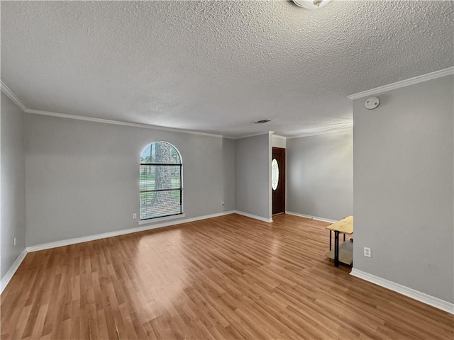 115 Spruce Cir, Slidell, LA 70458 - spare room with a textured ceiling, crown molding, light wood-style floors, and a smoke detector