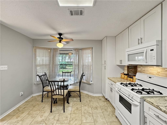 115 Spruce Cir, Slidell, LA 70458 - kitchen with white appliances, tasteful backsplash, a ceiling fan, white cabinets, and a textured ceiling