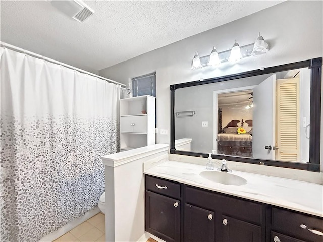 115 Spruce Cir, Slidell, LA 70458 - full bath featuring vanity, a textured ceiling, tile patterned flooring, ensuite bath, and a shower with curtain