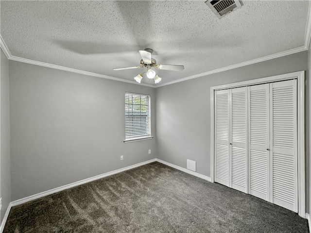 115 Spruce Cir, Slidell, LA 70458 - unfurnished bedroom with dark carpet, a closet, ornamental molding, a textured ceiling, and a ceiling fan