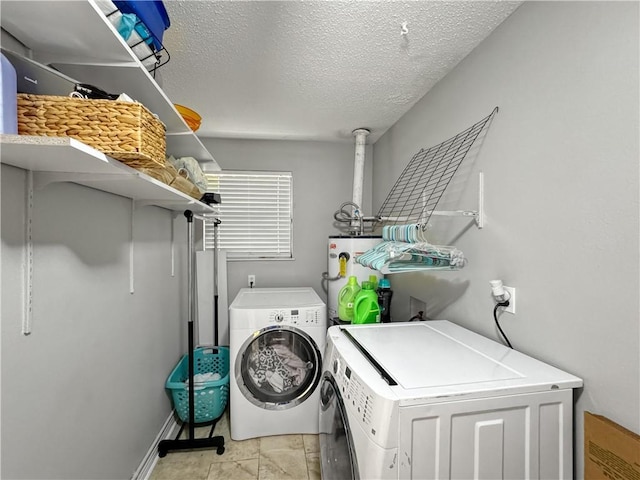 115 Spruce Cir, Slidell, LA 70458 - laundry room featuring washing machine and clothes dryer, electric water heater, and a textured ceiling