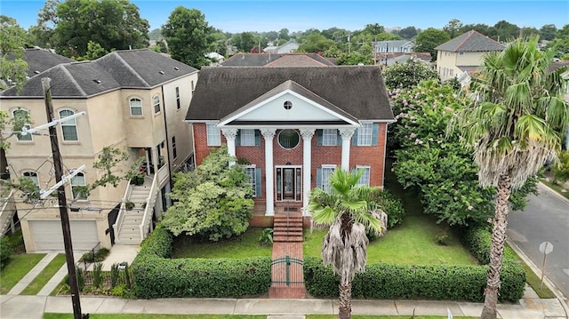4232 Fontainebleau Dr, New Orleans, LA 70125 - view of front of house with brick siding, an attached garage, and a residential view