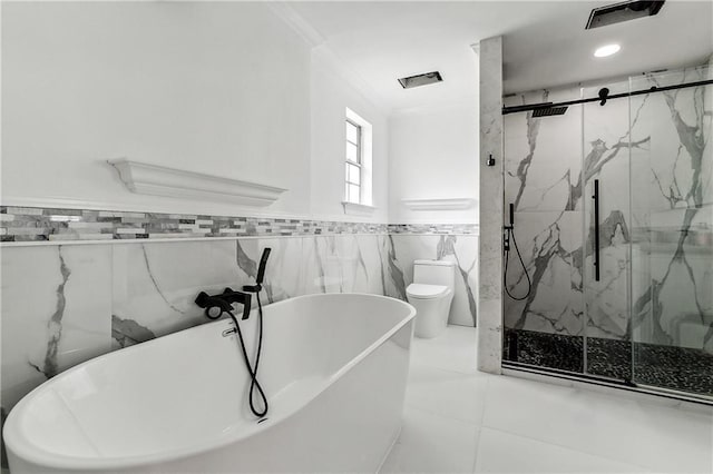 bathroom featuring crown molding, tile walls, toilet, a marble finish shower, and a soaking tub