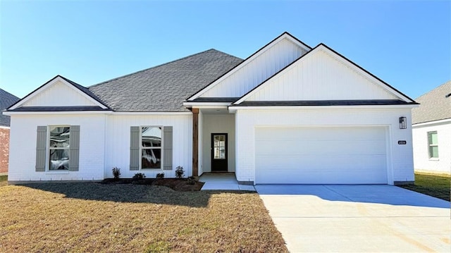 modern farmhouse style home with driveway, a front lawn, roof with shingles, and a garage
