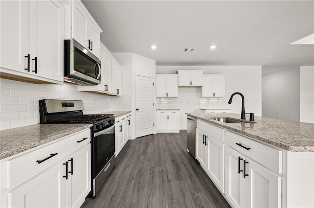 kitchen featuring a sink, white cabinets, stainless steel appliances, and dark wood finished floors