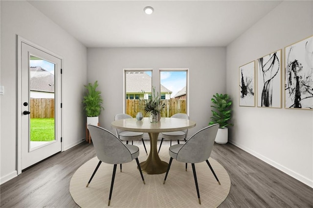 dining space featuring baseboards and dark wood-style floors