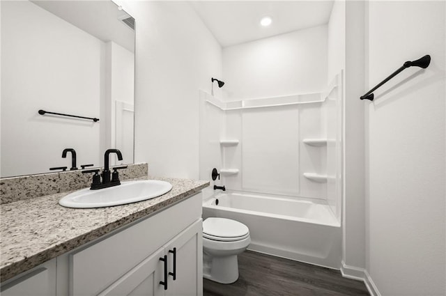 full bathroom featuring vanity, wood finished floors, toilet, recessed lighting, and shower / washtub combination