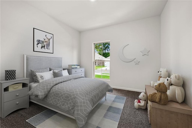 bedroom featuring baseboards and dark carpet