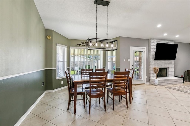 dining area with a brick fireplace, recessed lighting, baseboards, and light tile patterned floors