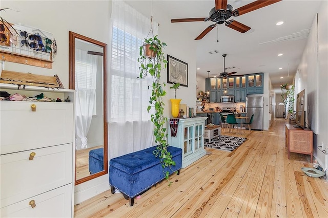 interior space featuring a ceiling fan, recessed lighting, and light wood-type flooring