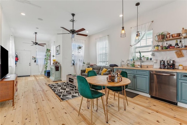 interior space with a ceiling fan, recessed lighting, light wood finished floors, and visible vents