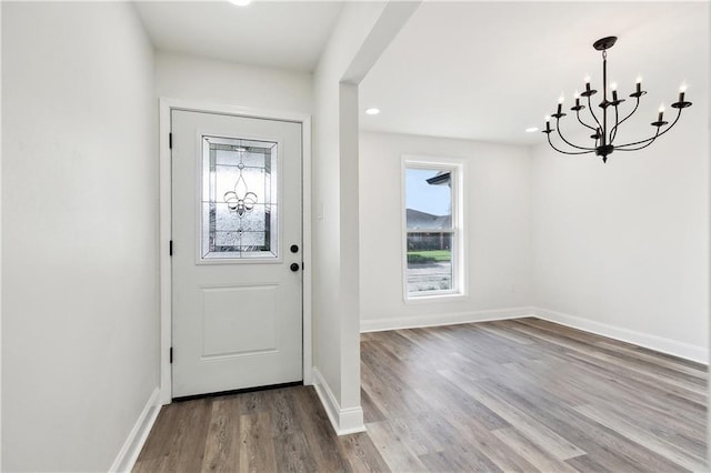 foyer entrance with an inviting chandelier, recessed lighting, baseboards, and wood finished floors