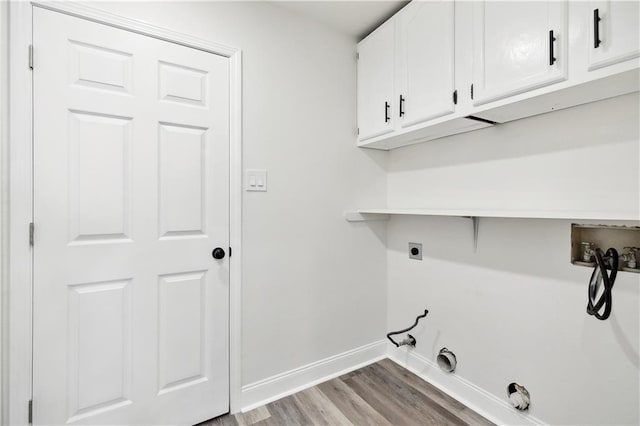 laundry room featuring washer hookup, hookup for an electric dryer, cabinet space, baseboards, and light wood-style flooring