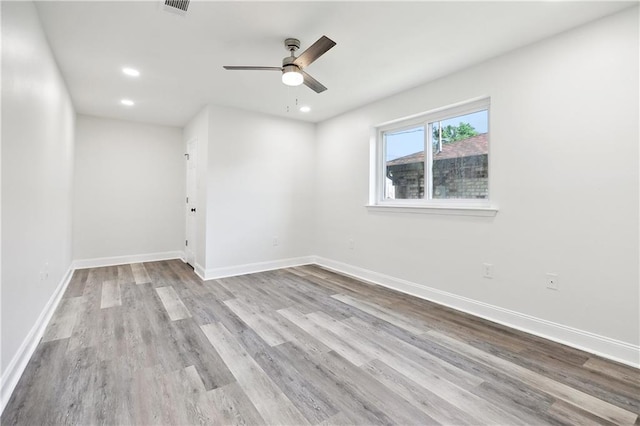 spare room featuring baseboards, a ceiling fan, recessed lighting, and wood finished floors