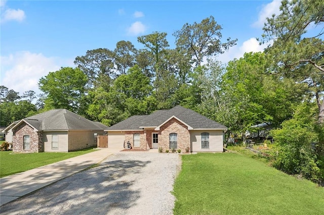 ranch-style house with brick siding, an attached garage, driveway, and a front yard