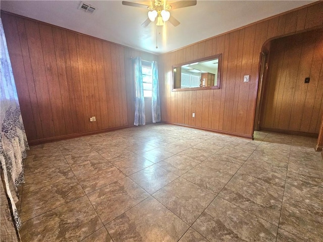 813 2nd Ave, Harvey, LA 70058 - unfurnished room featuring a ceiling fan, wood walls, and visible vents