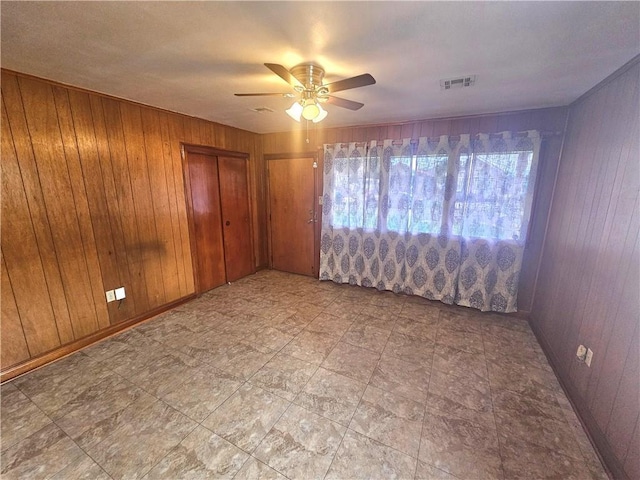 813 2nd Ave, Harvey, LA 70058 - empty room with a ceiling fan, wood walls, and visible vents