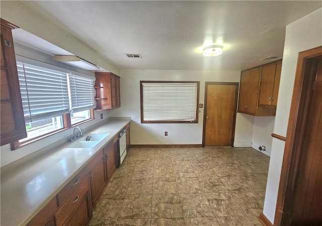 813 2nd Ave, Harvey, LA 70058 - kitchen featuring brown cabinetry, visible vents, dishwasher, a sink, and light countertops