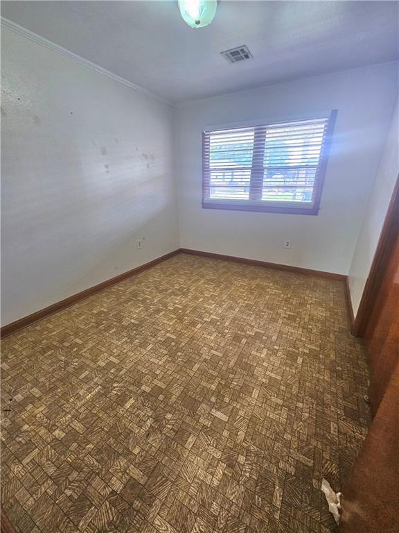 813 2nd Ave, Harvey, LA 70058 - spare room with visible vents, ornamental molding, and baseboards