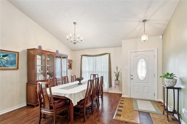 1734 Barrymore St, Slidell, LA 70461 - dining space featuring baseboards, a chandelier, vaulted ceiling, and dark wood-style floors