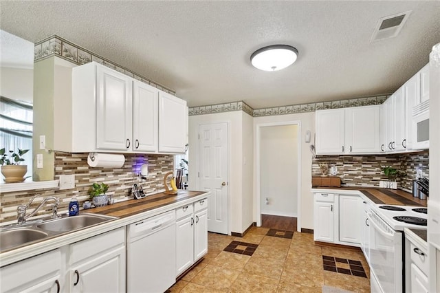 1734 Barrymore St, Slidell, LA 70461 - kitchen with white appliances, white cabinets, visible vents, and a sink