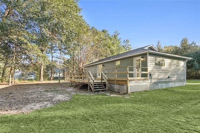 back of property featuring a lawn and a wooden deck