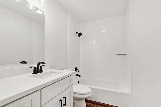 bathroom featuring vanity, shower / tub combination, wood finished floors, and toilet