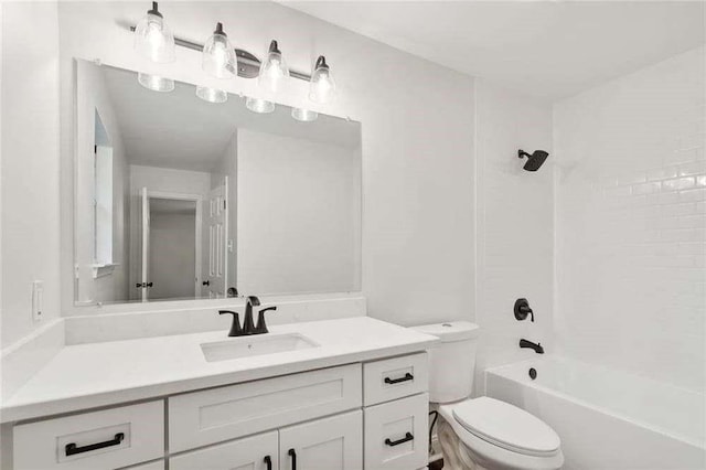 bathroom featuring vanity, bathtub / shower combination, and toilet