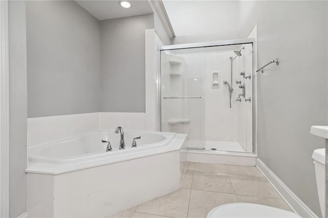 full bathroom with a garden tub, baseboards, toilet, and a shower stall