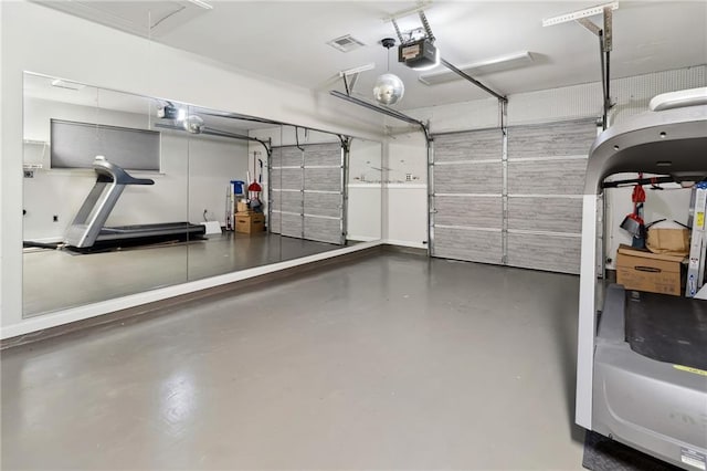 garage featuring a garage door opener and visible vents
