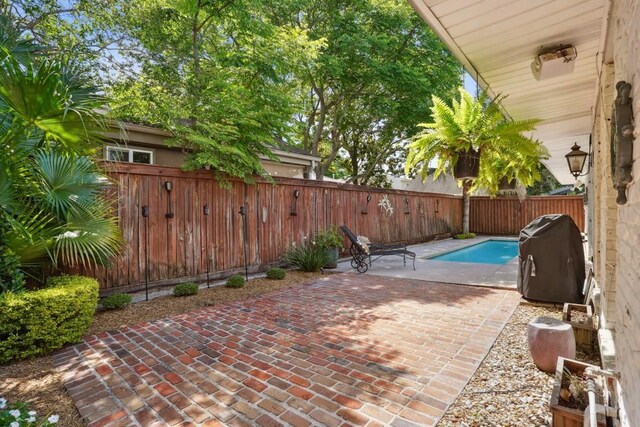 3909 Courtland St, Metairie, LA 70002 - view of patio featuring a fenced in pool, a fenced backyard, and a grill