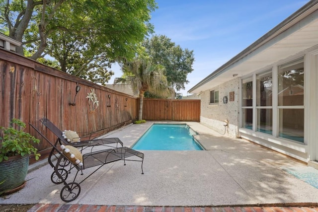 view of pool featuring a fenced in pool, a fenced backyard, and a patio area