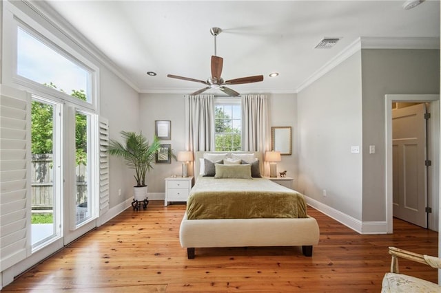 bedroom featuring crown molding, baseboards, visible vents, and access to exterior