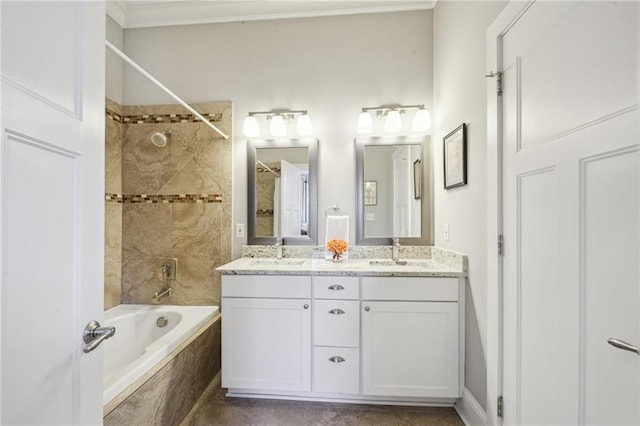 full bath featuring a sink, bathing tub / shower combination, ornamental molding, and double vanity