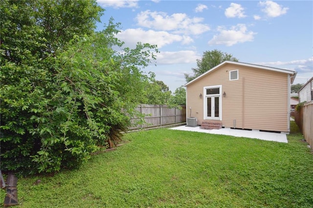 back of house featuring cooling unit, a patio, a fenced backyard, entry steps, and a yard