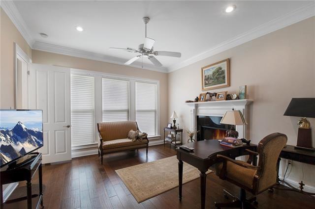 office space featuring recessed lighting, ceiling fan, ornamental molding, and hardwood / wood-style floors