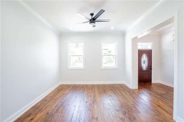 foyer entrance with crown molding, a ceiling fan, baseboards, and wood finished floors